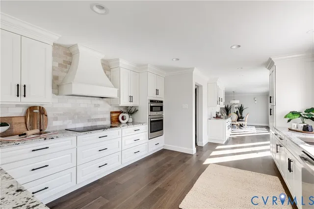 a kitchen with granite countertop a sink and cabinets