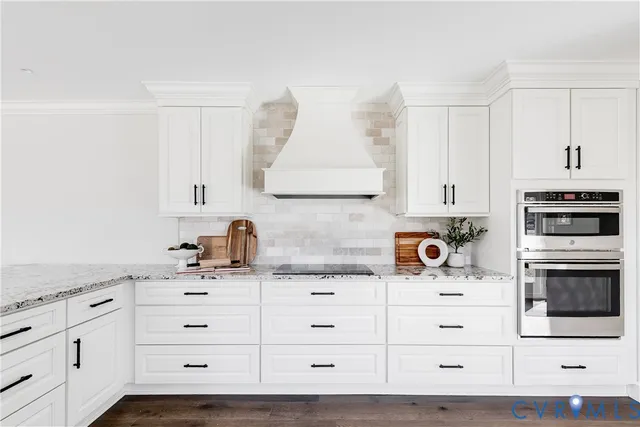 a kitchen with granite countertop white cabinets and white appliances