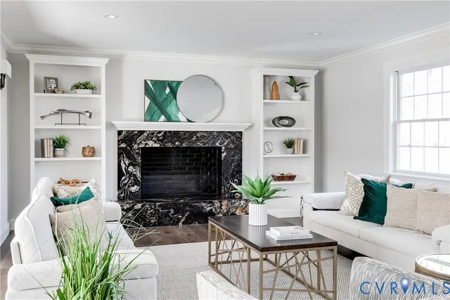 a living room with furniture a fireplace a window and a window