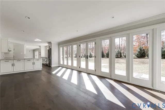 a view of empty room with a fireplace and wooden floor