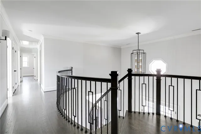 a view of hallway with stairs to wooden floor and a chandelier
