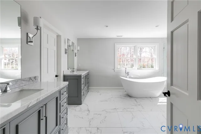 a spacious bathroom with a bathtub sink and toilet
