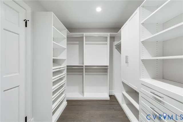 a view of walk in closet with empty racks