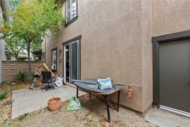 a backyard of a house with table and chairs