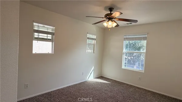 a bedroom with a bed and a potted plant