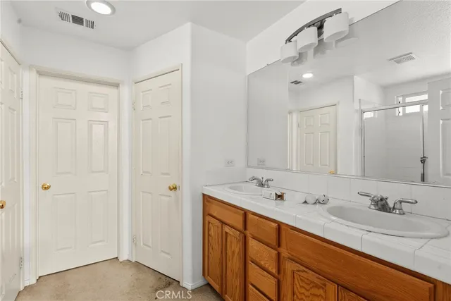 a bathroom with a sink double vanity and a mirror
