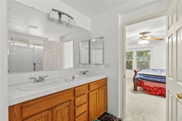 a bathroom with a sink double vanity and a shower