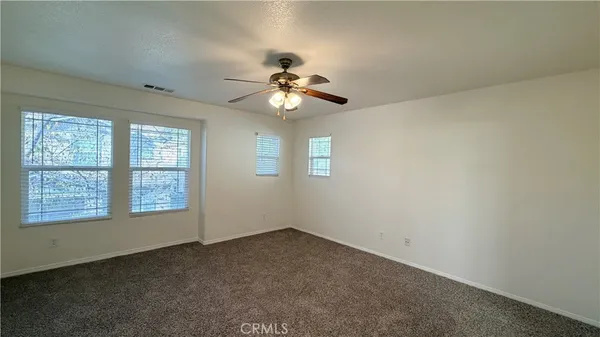 a patio with a table and chairs under an umbrella