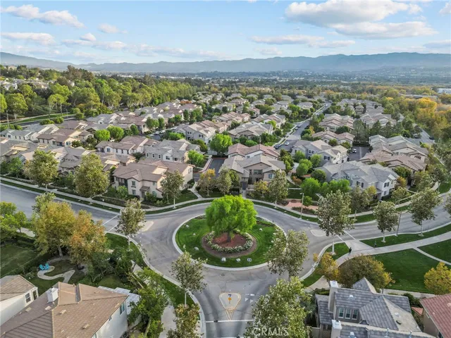 an aerial view of a residential houses with outdoor space and street view