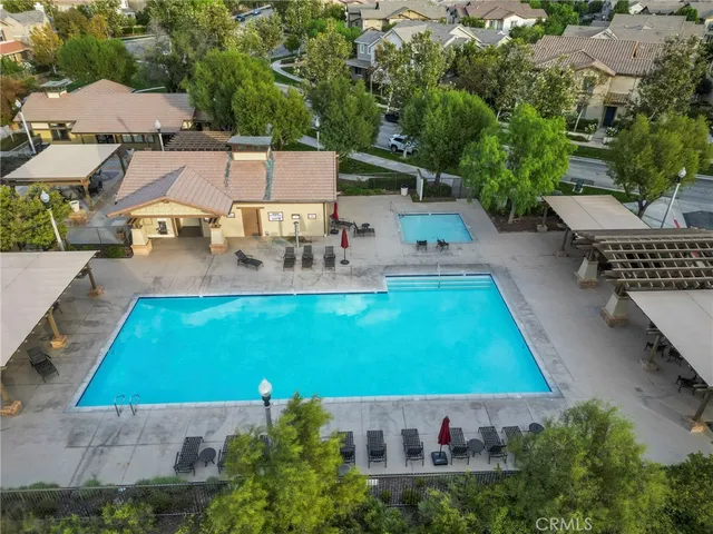 an aerial view of a house with swimming pool patio and outdoor seating