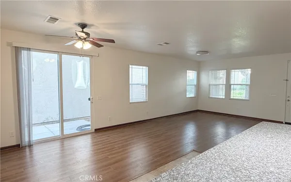 a kitchen with granite countertop a refrigerator stove and sink