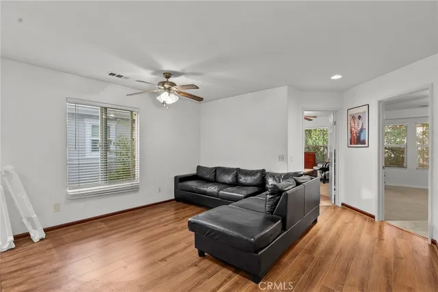 a living room with furniture and wooden floor