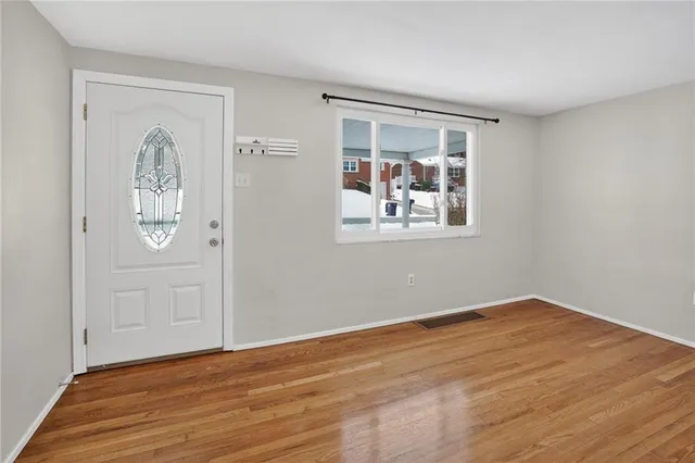 wooden floor in an empty room with a window