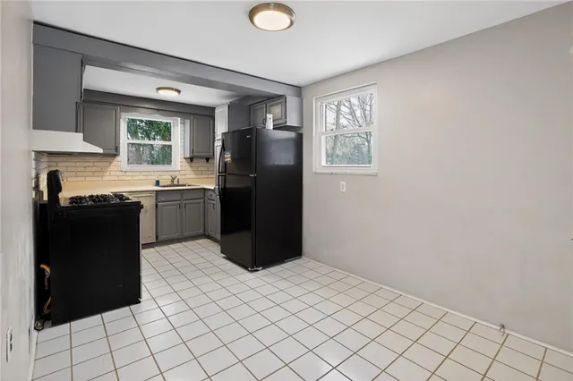 a kitchen with stainless steel appliances granite countertop a refrigerator and a sink