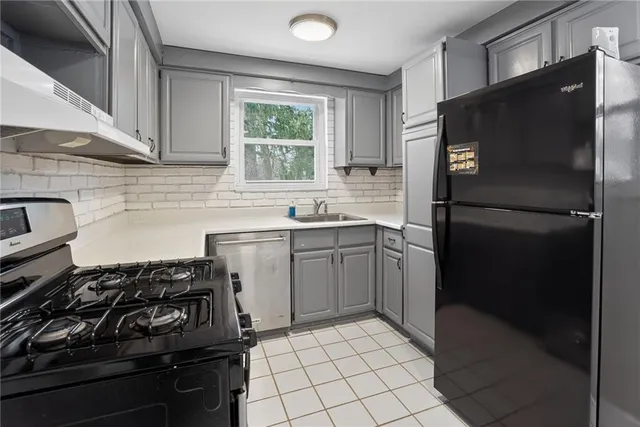 a kitchen with a sink stove and refrigerator