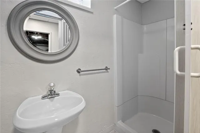 a bathroom with a sink a mirror and a toilet