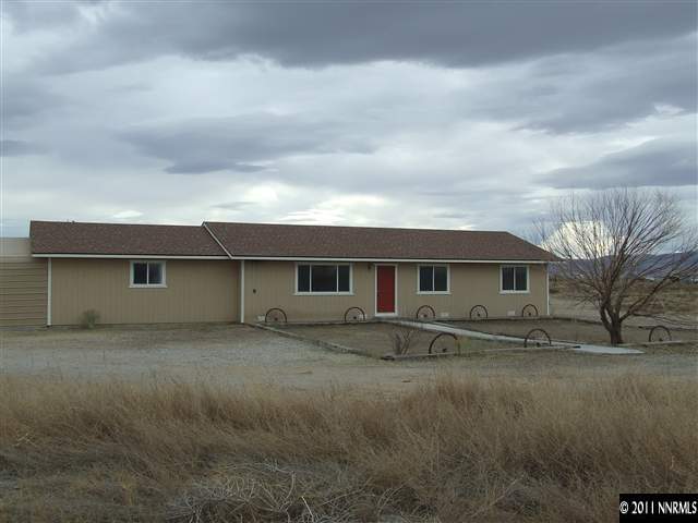 7470 Sandhill Road Fallon, NV 89406 - Photo 1 of 6 a front view of a house with a yard