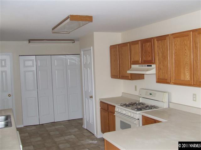 7470 Sandhill Road Fallon, NV 89406 - Photo 2 of 6 a kitchen with a stove and a cabinet