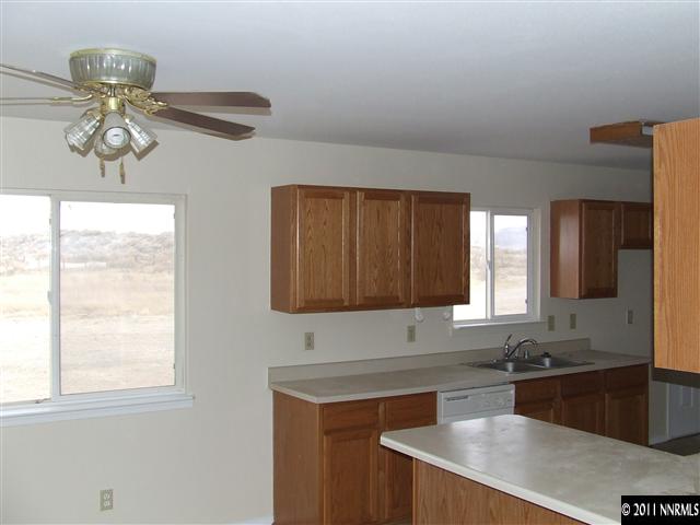 7470 Sandhill Road Fallon, NV 89406 - Photo 3 of 6 a kitchen with stainless steel appliances granite countertop a sink a stove and a microwave