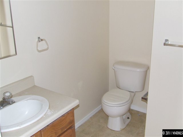 7470 Sandhill Road Fallon, NV 89406 - Photo 5 of 6 a bathroom with a toilet sink and mirror