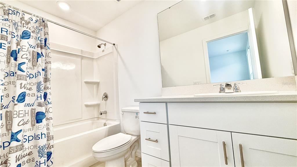 3244 Skyline Loop Kissimmee, FL 34758 - Photo 5 of 13 a bathroom with a sink a toilet and a bathtub