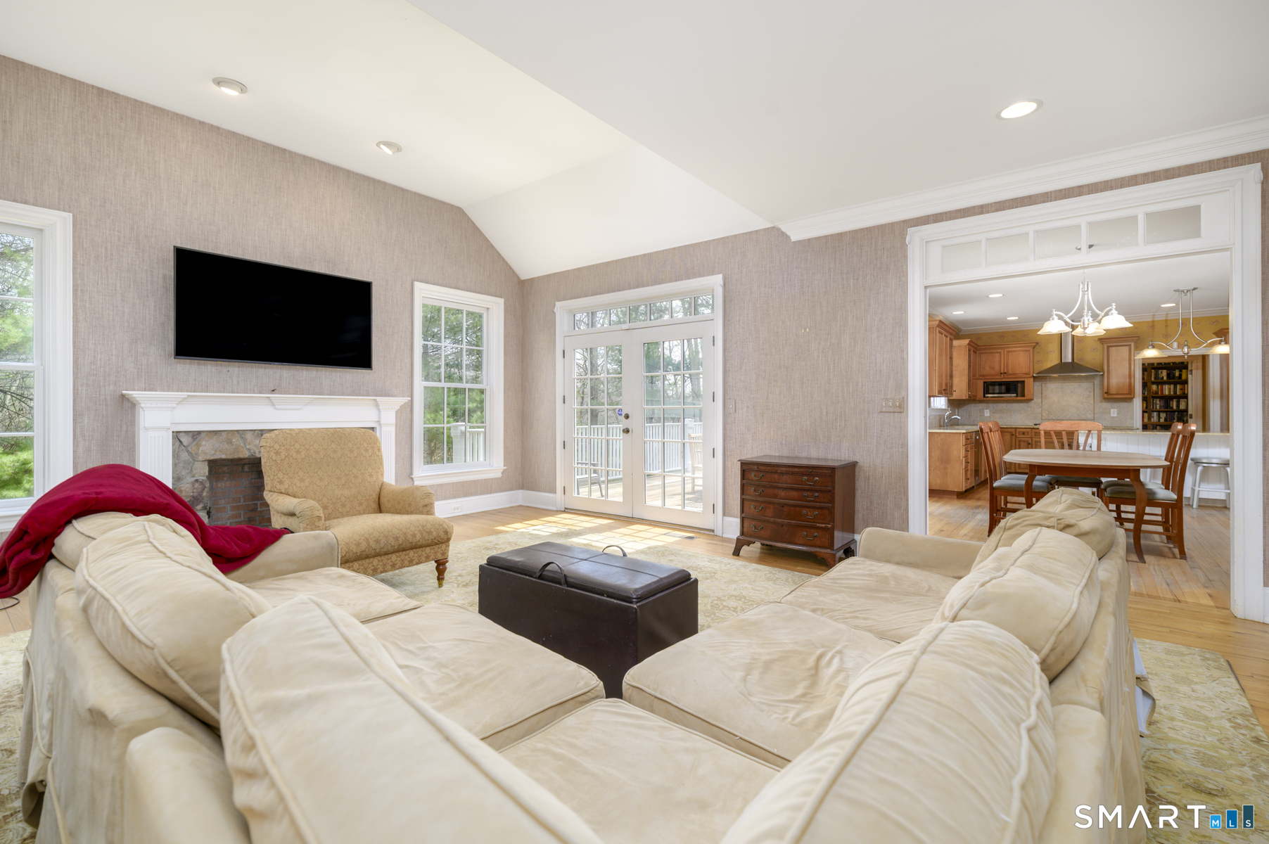 53 Wolfpit Road Wilton, CT 06897 - Photo 13 of 40 a living room with fireplace furniture and a flat screen tv