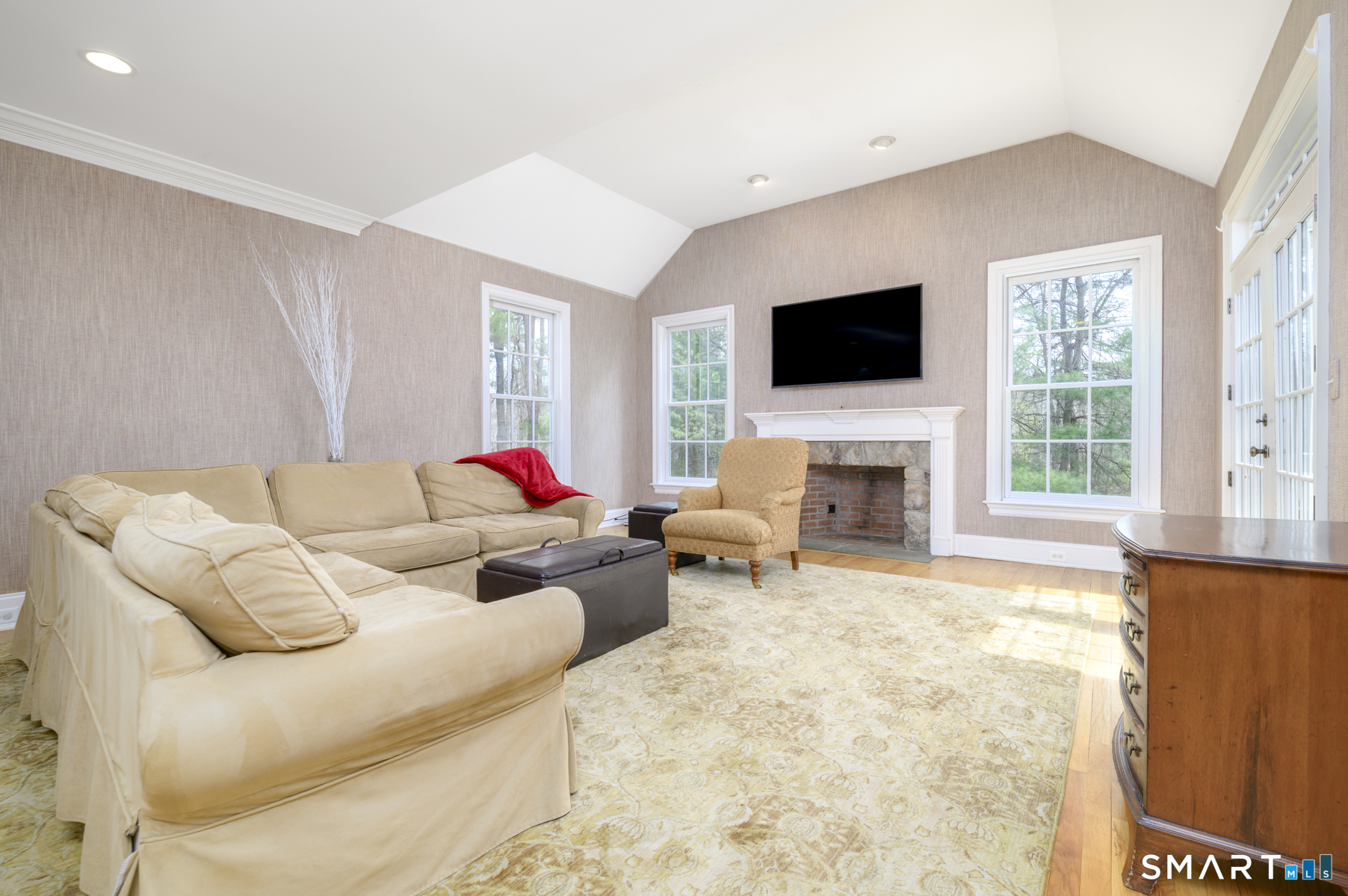 53 Wolfpit Road Wilton, CT 06897 - Photo 14 of 40 a living room with furniture and a flat screen tv