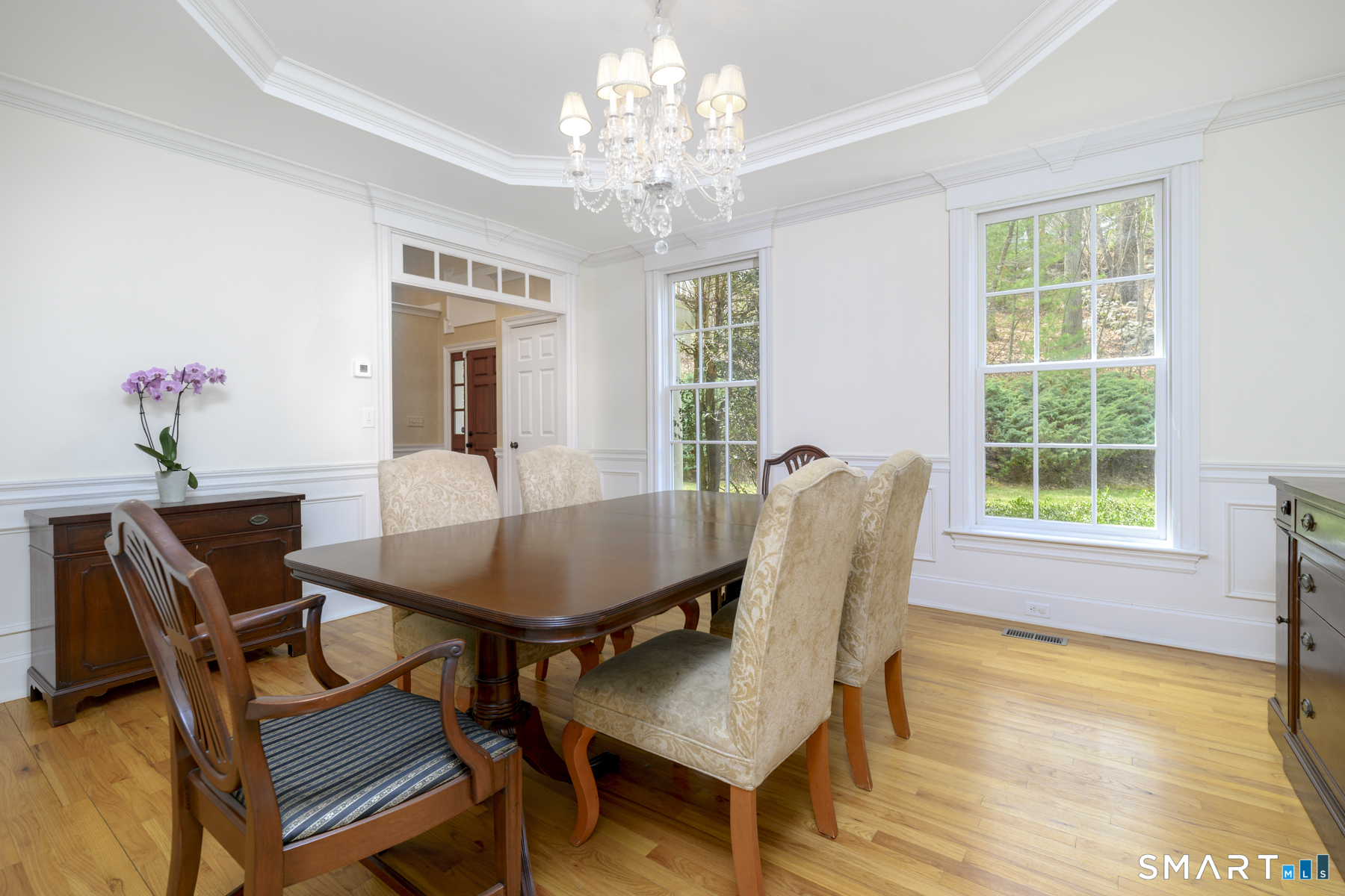 53 Wolfpit Road Wilton, CT 06897 - Photo 17 of 40 a dining room with furniture a chandelier and wooden floor