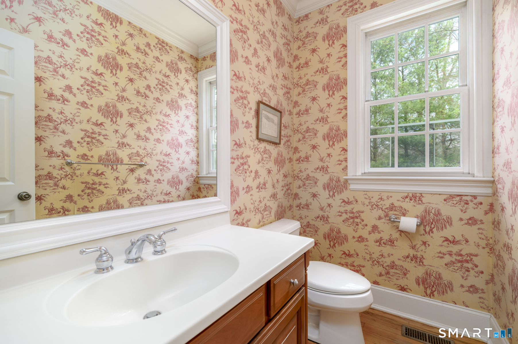 53 Wolfpit Road Wilton, CT 06897 - Photo 19 of 40 a bathroom with a sink a toilet and a mirror