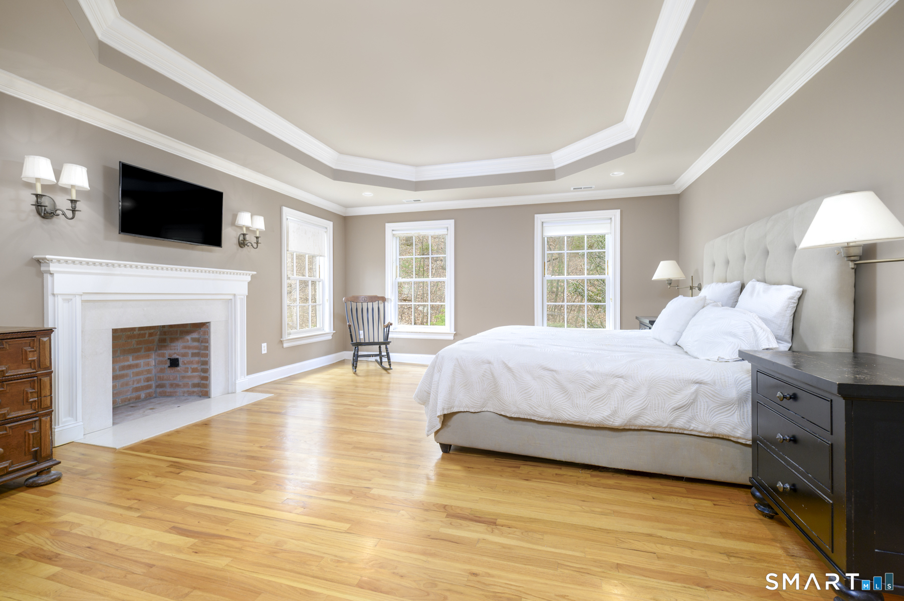 53 Wolfpit Road Wilton, CT 06897 - Photo 22 of 40 a spacious bedroom with a large bed and a fireplace