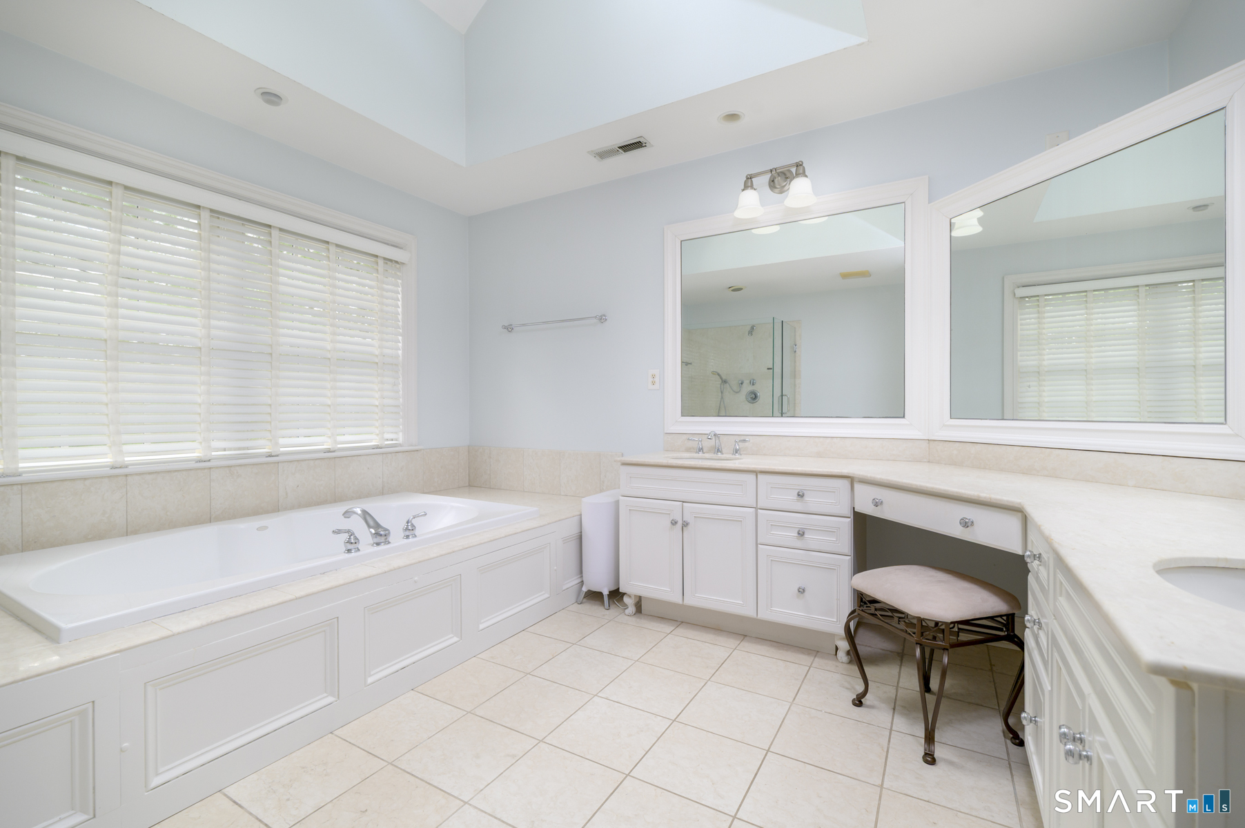 53 Wolfpit Road Wilton, CT 06897 - Photo 24 of 40 a bathroom with a tub sink and a chair