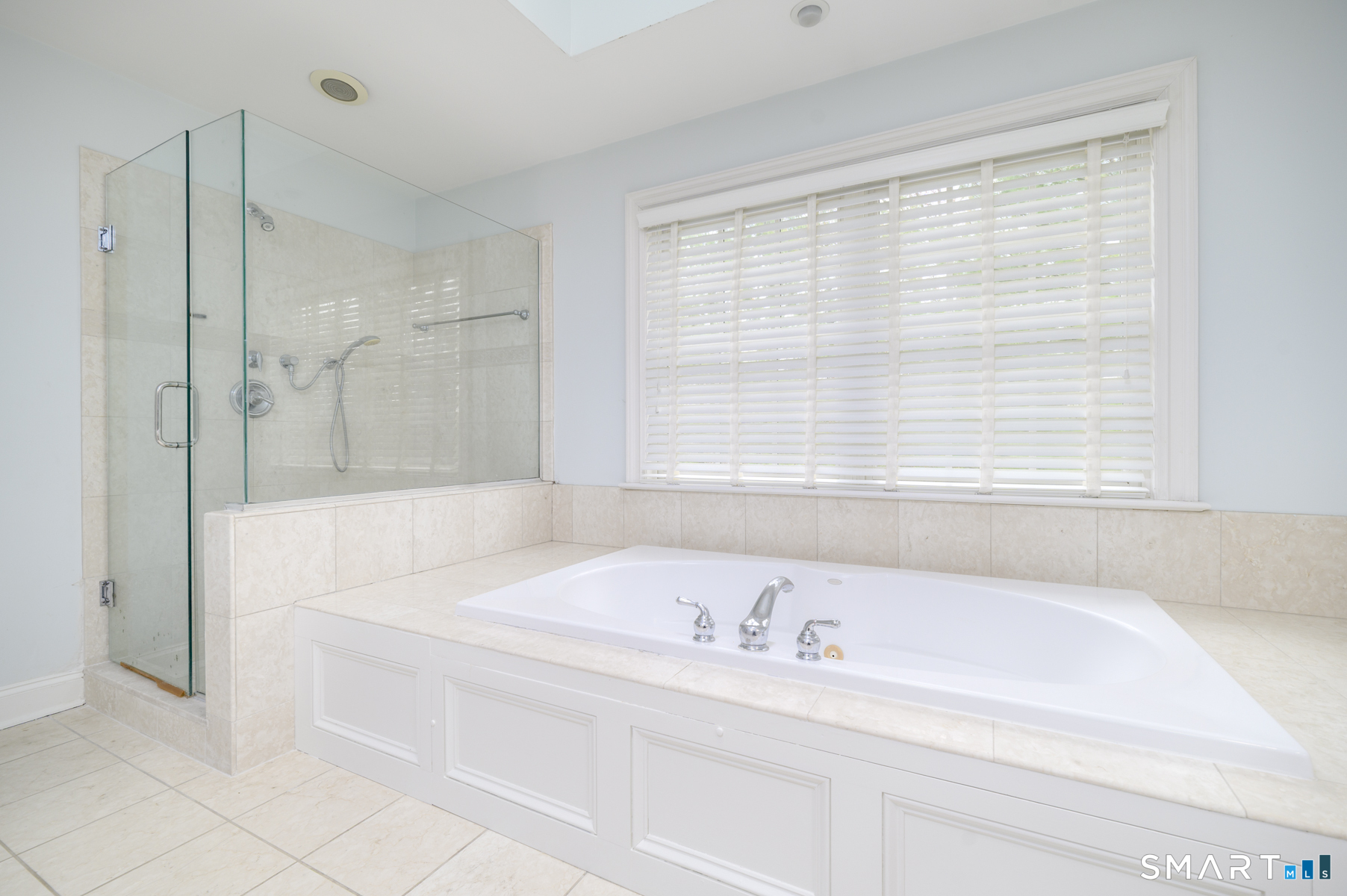 53 Wolfpit Road Wilton, CT 06897 - Photo 25 of 40 a bathroom with a bathtub and a shower