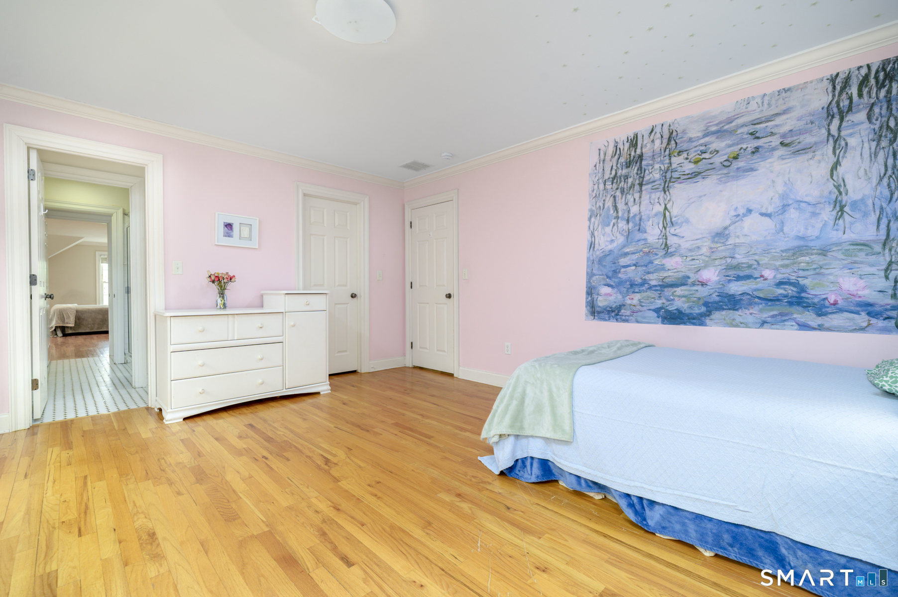 53 Wolfpit Road Wilton, CT 06897 - Photo 27 of 40 a bedroom with a bed and a painting on the wall