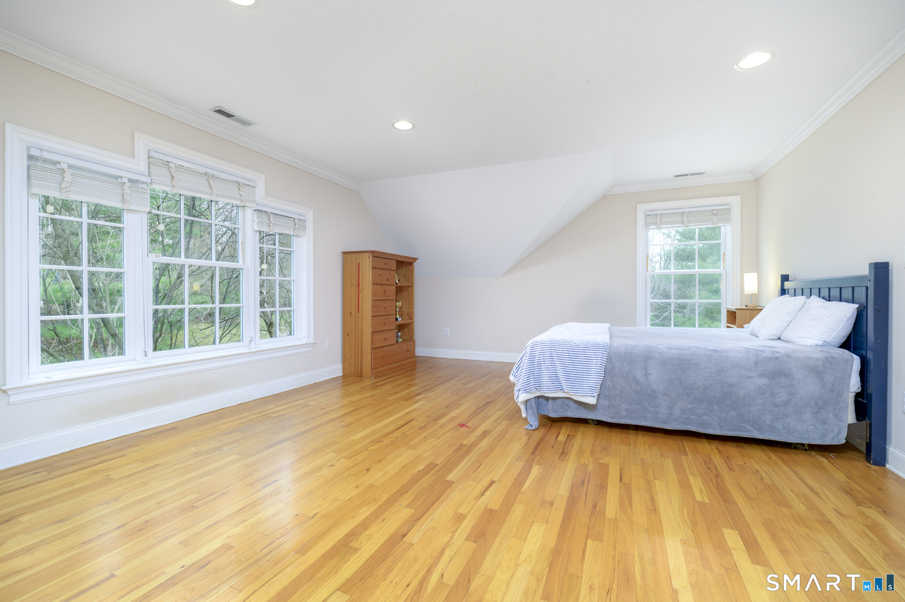 53 Wolfpit Road Wilton, CT 06897 - Photo 29 of 40 a bedroom with a bed and wooden floor