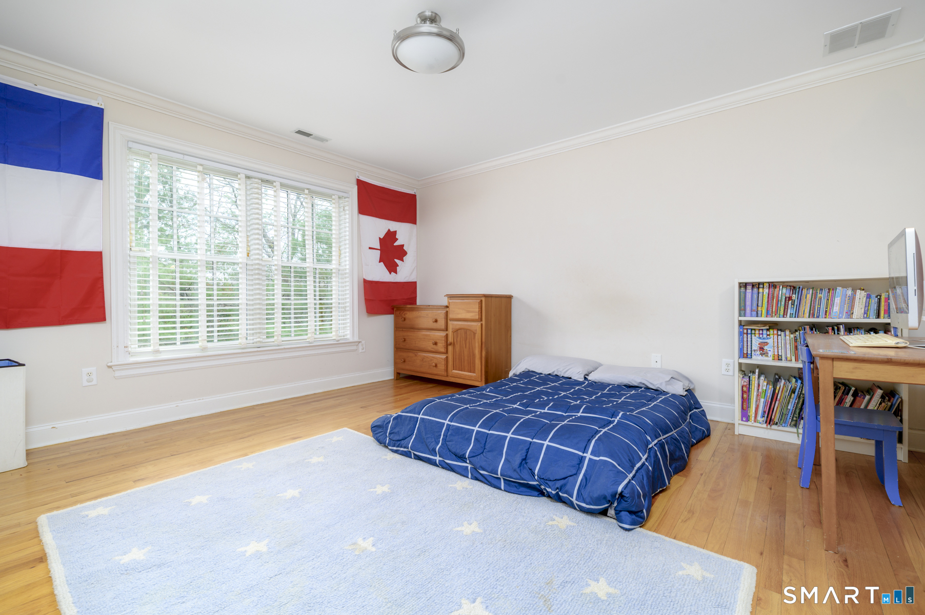 53 Wolfpit Road Wilton, CT 06897 - Photo 32 of 40 a bedroom with a bed and a book shelf