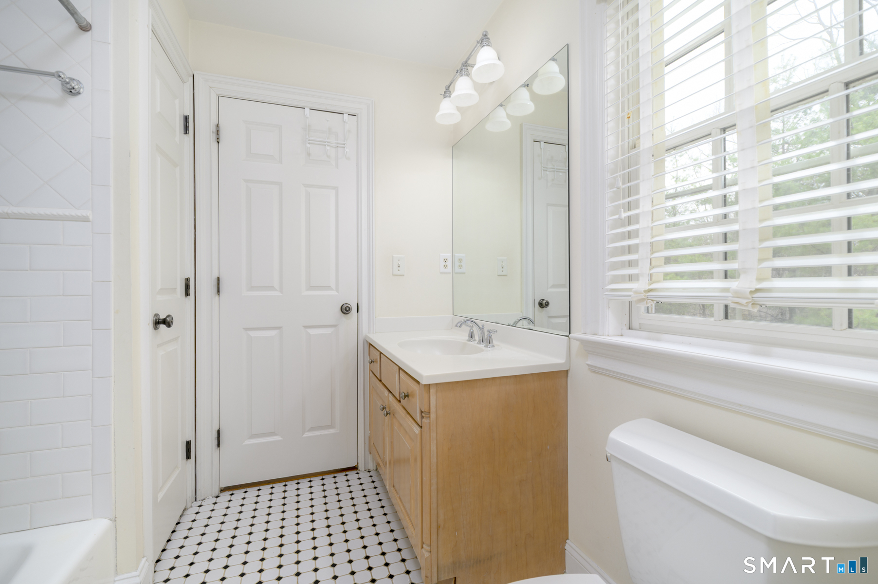 53 Wolfpit Road Wilton, CT 06897 - Photo 33 of 40 a bathroom with a sink a toilet and a window