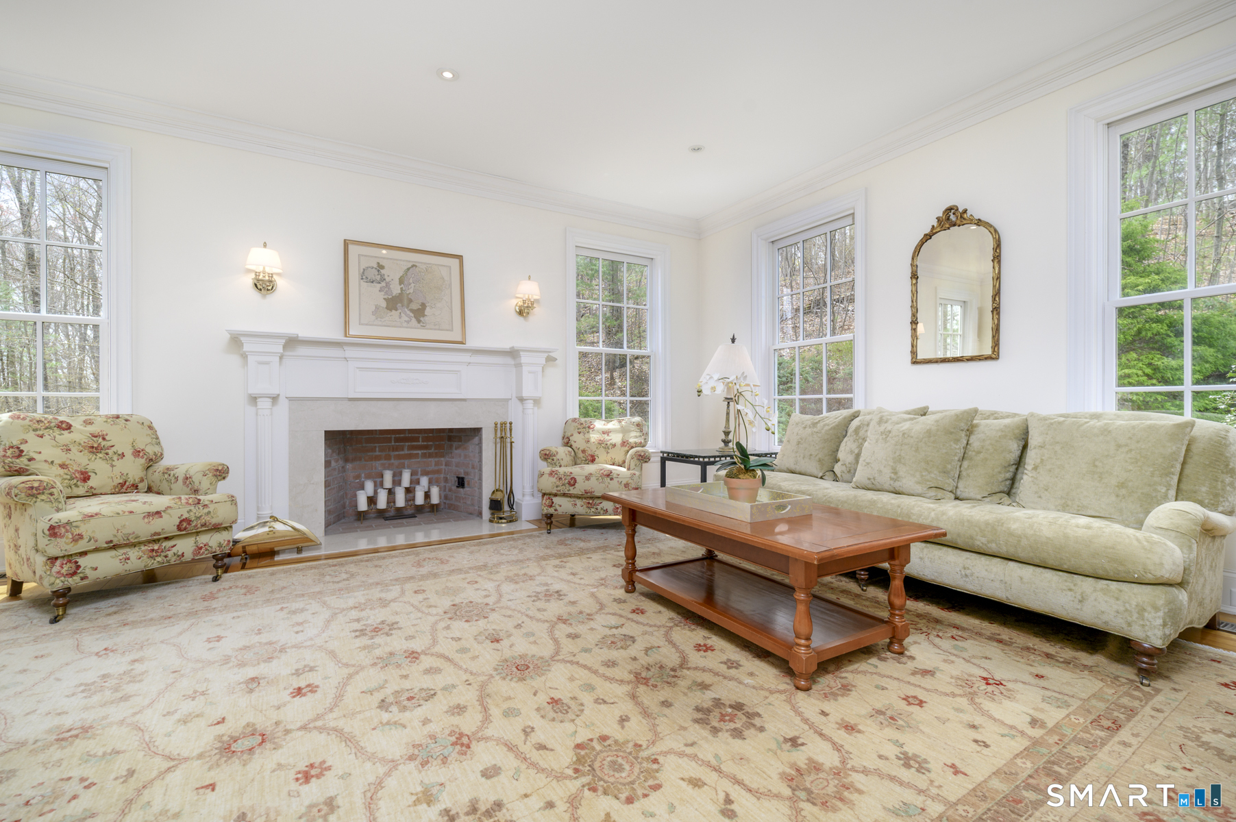 53 Wolfpit Road Wilton, CT 06897 - Photo 5 of 40 a living room with furniture and a fireplace