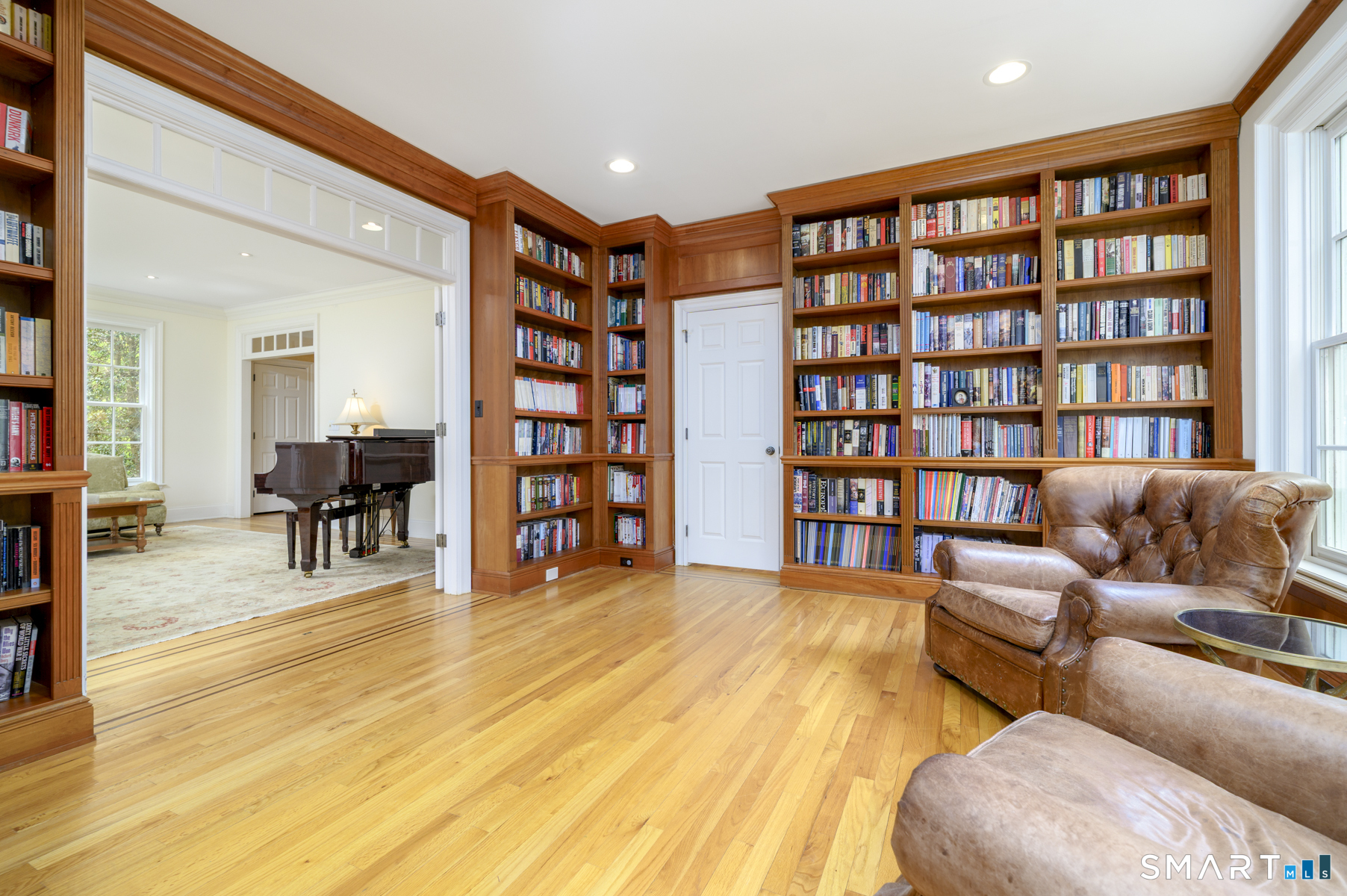 53 Wolfpit Road Wilton, CT 06897 - Photo 6 of 40 a living room with furniture and a book shelf