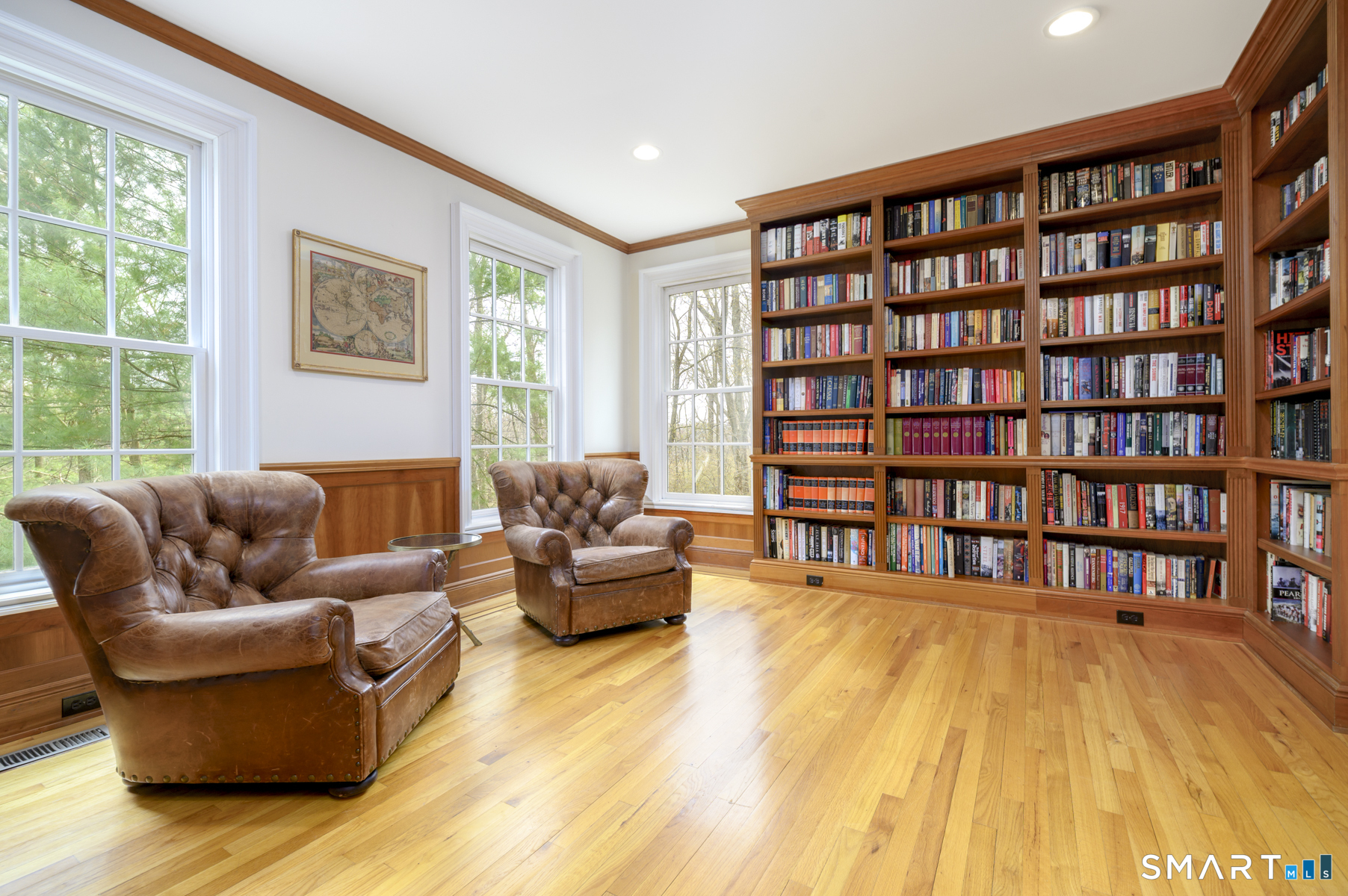 53 Wolfpit Road Wilton, CT 06897 - Photo 7 of 40 a living room with furniture and a book shelf