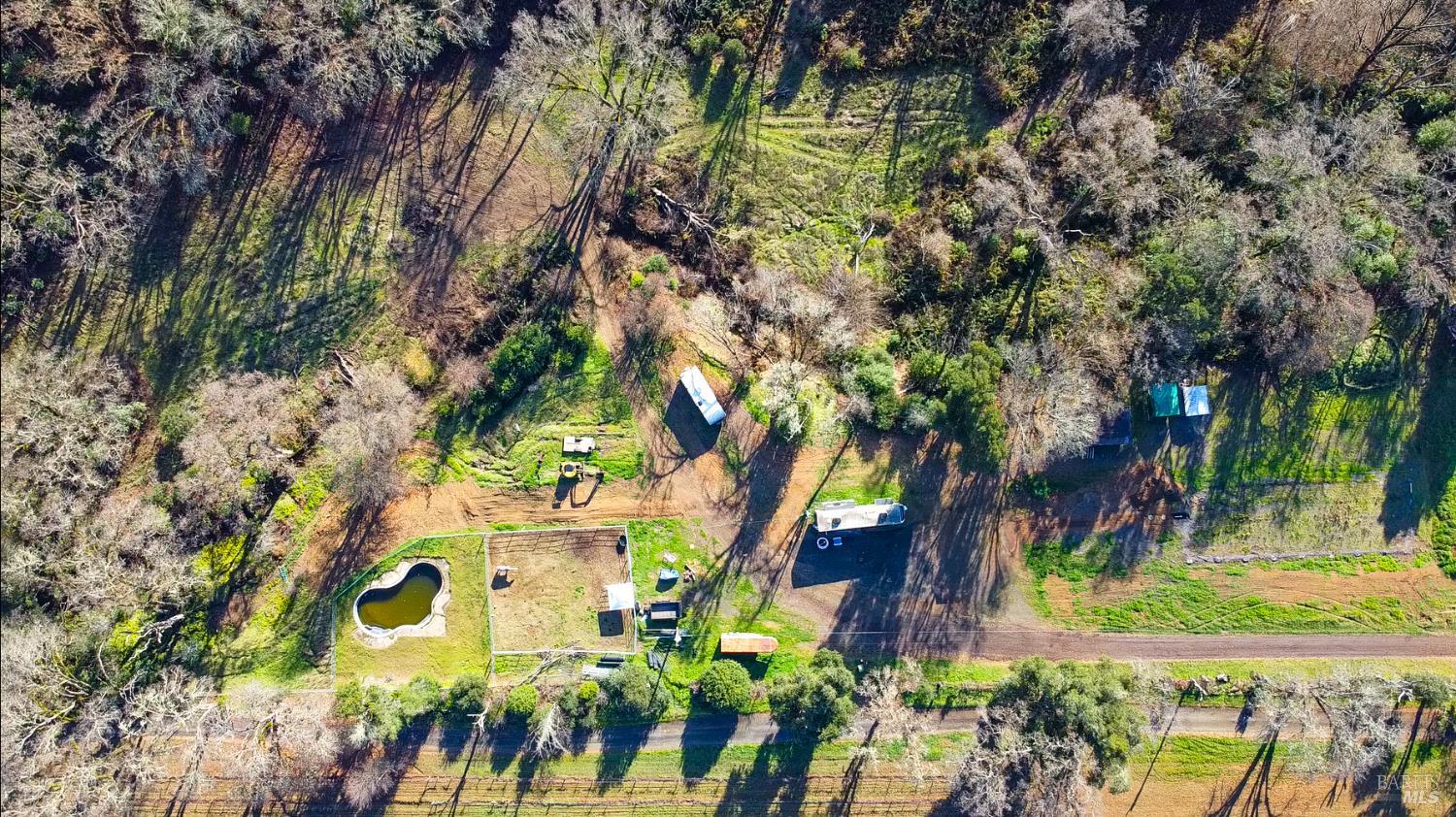 an aerial view of residential houses with yard