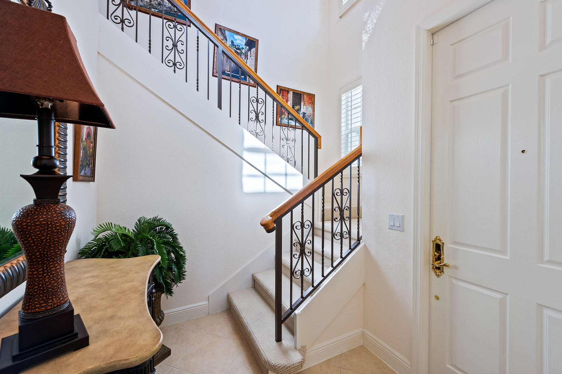 9259 Museo Circle, Unit 203 Naples, FL 34114 - Photo 2 of 46 a view of entryway with wooden floor and stairs