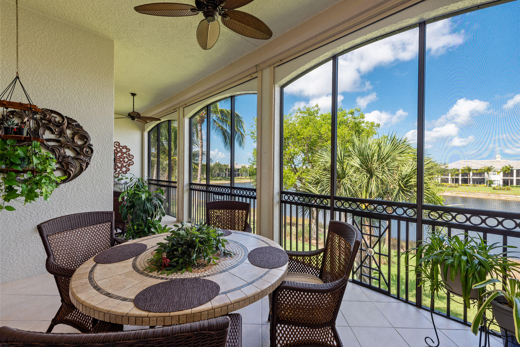 9259 Museo Circle, Unit 203 Naples, FL 34114 - Photo 22 of 46 a view of a balcony with chairs and a potted plant