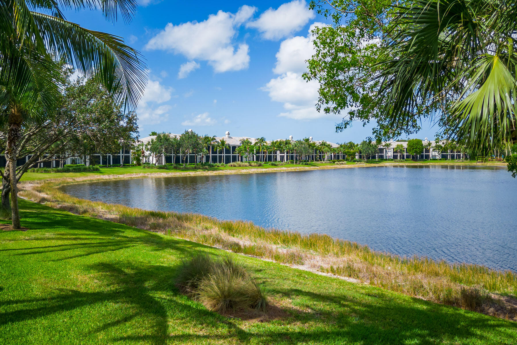 9259 Museo Circle, Unit 203 Naples, FL 34114 - Photo 24 of 46 a view of a lake with a big yard