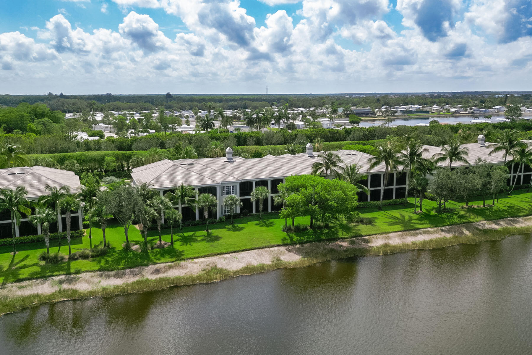 9259 Museo Circle, Unit 203 Naples, FL 34114 - Photo 26 of 46 a view of a lake with a city