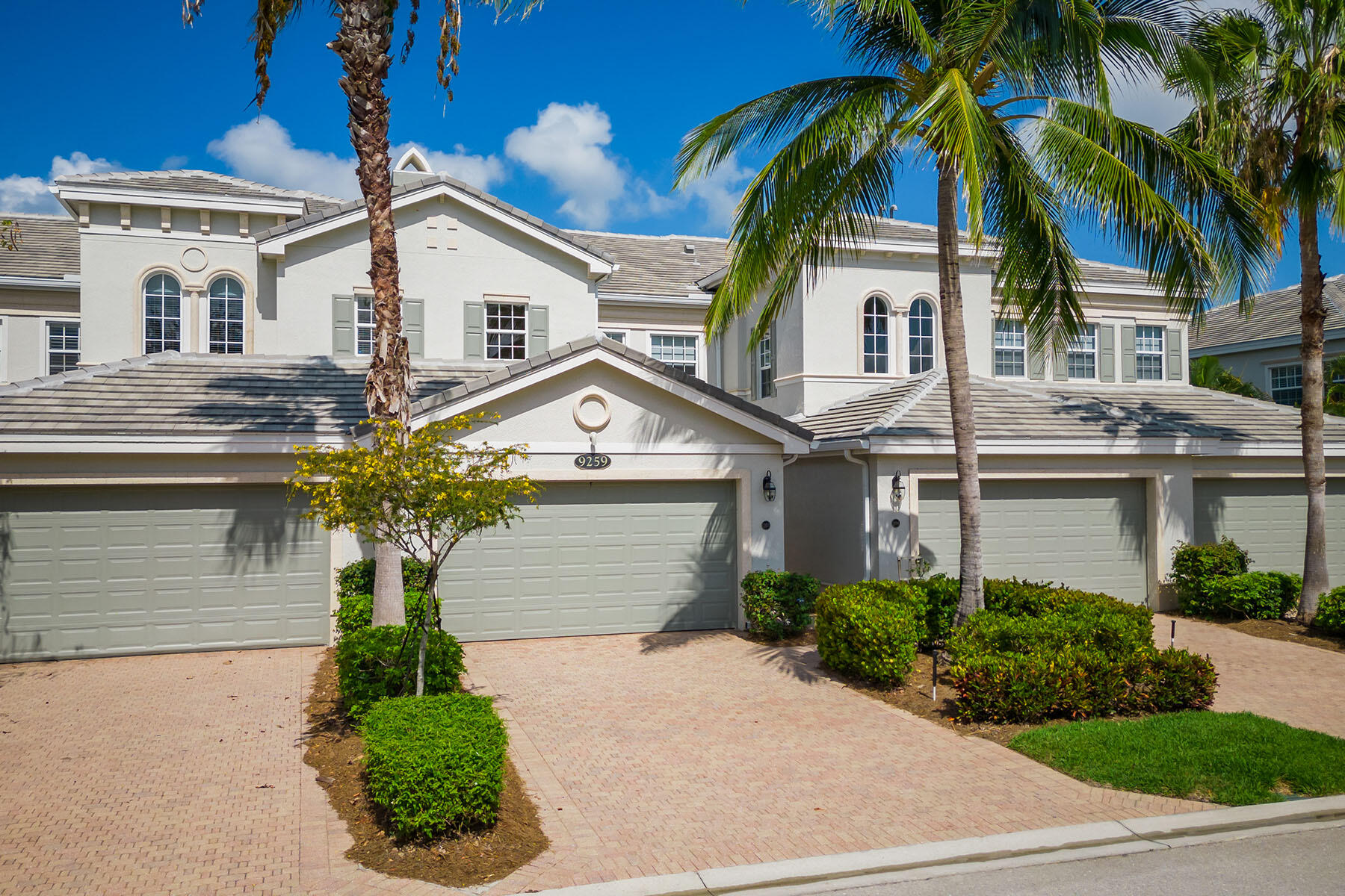 9259 Museo Circle, Unit 203 Naples, FL 34114 - Photo 28 of 46 a front view of a house with a yard