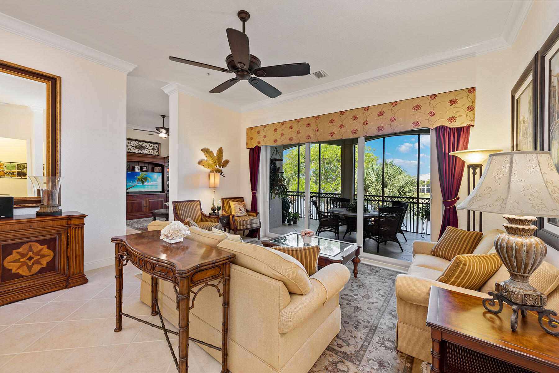 9259 Museo Circle, Unit 203 Naples, FL 34114 - Photo 3 of 46 a living room with furniture a ceiling fan and a large window