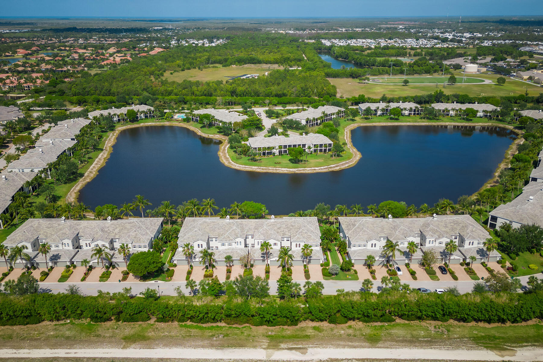 9259 Museo Circle, Unit 203 Naples, FL 34114 - Photo 31 of 46 an aerial view of residential houses with outdoor space