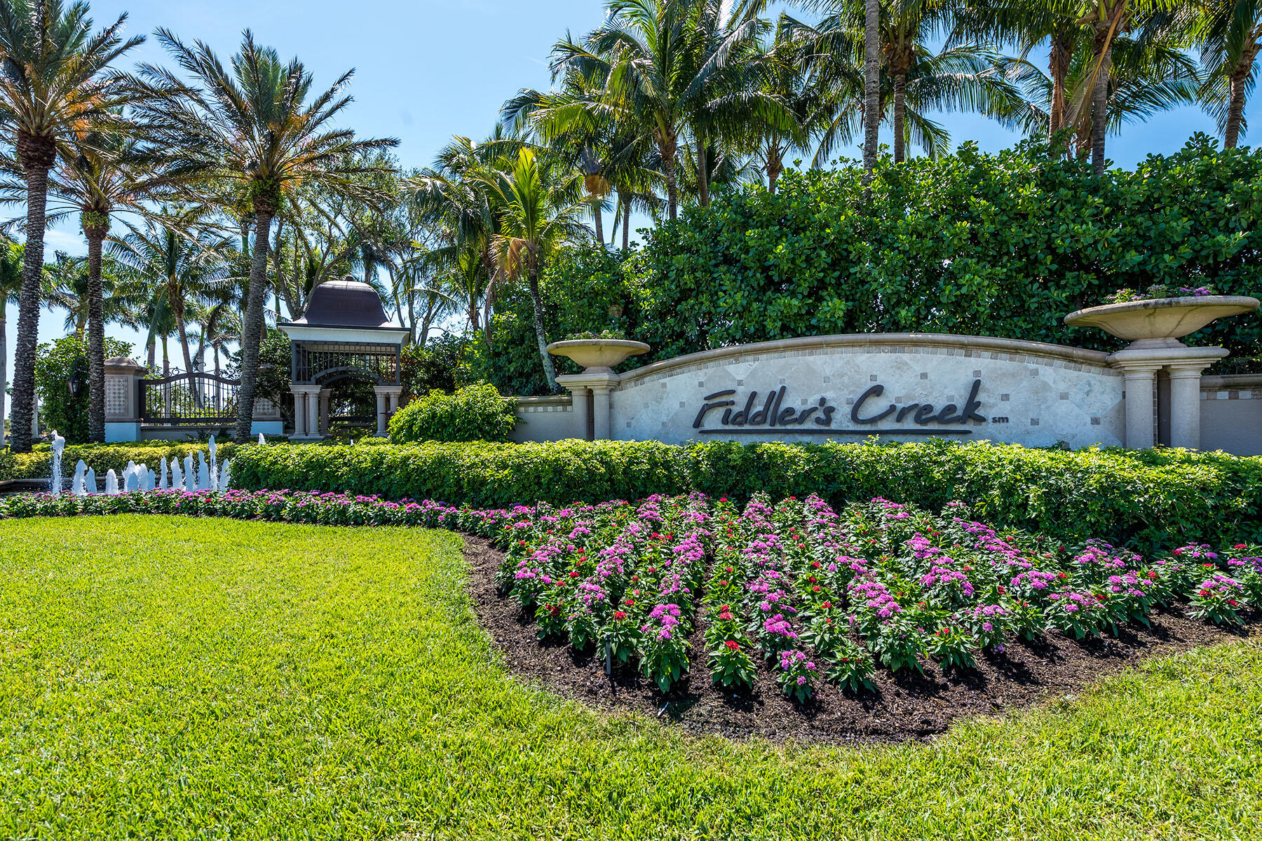 9259 Museo Circle, Unit 203 Naples, FL 34114 - Photo 33 of 46 a view of a garden with flowers and palm trees