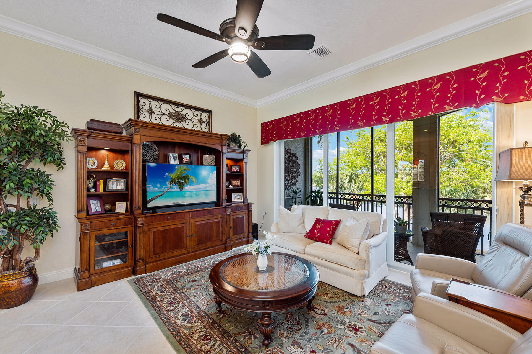9259 Museo Circle, Unit 203 Naples, FL 34114 - Photo 5 of 46 a living room with furniture a rug and a floor to ceiling window