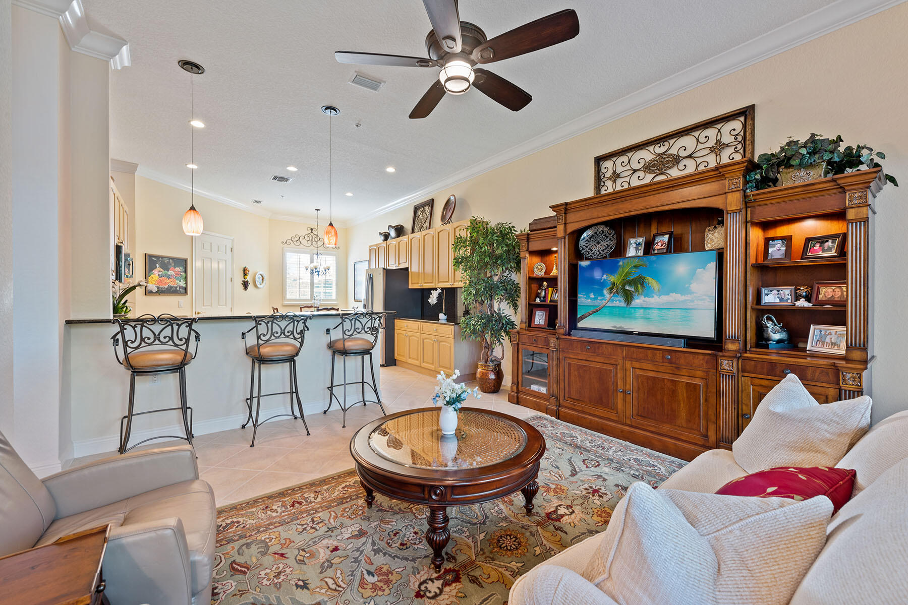 9259 Museo Circle, Unit 203 Naples, FL 34114 - Photo 6 of 46 a living room with furniture and a flat screen tv